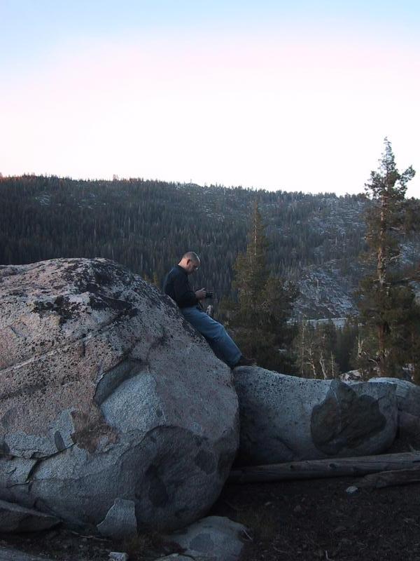 [Phil leaning against boulder]