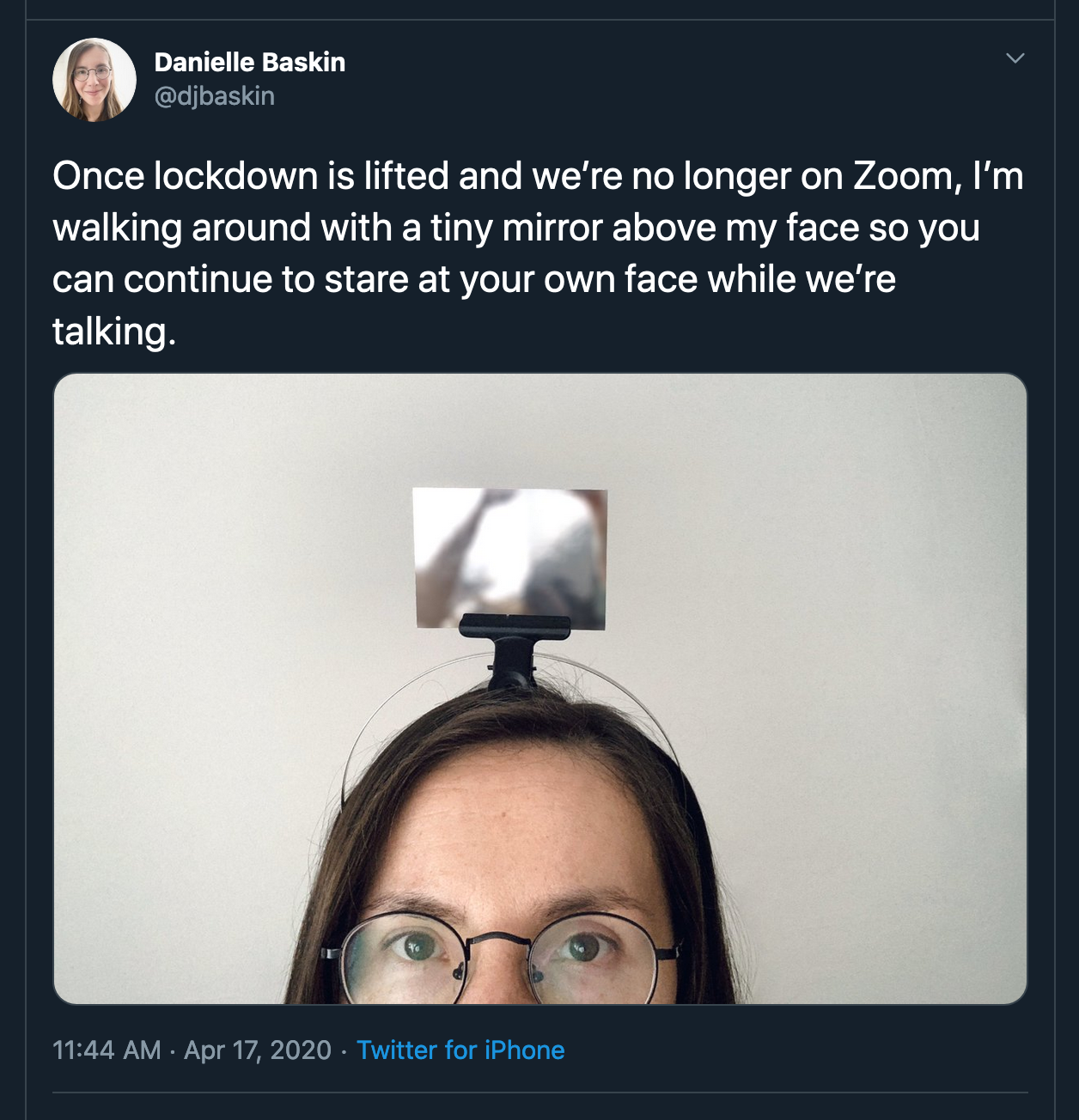 picture of woman with mirror attached to the top of her head like a GoPro mount